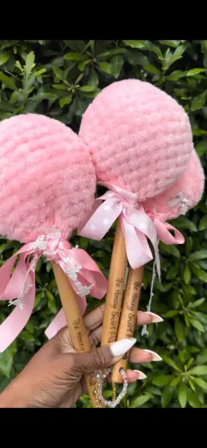 Hand holding decorative pink lollipops