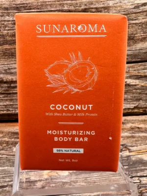Blue bar of goat's milk nourishing body bar placed on a wooden surface